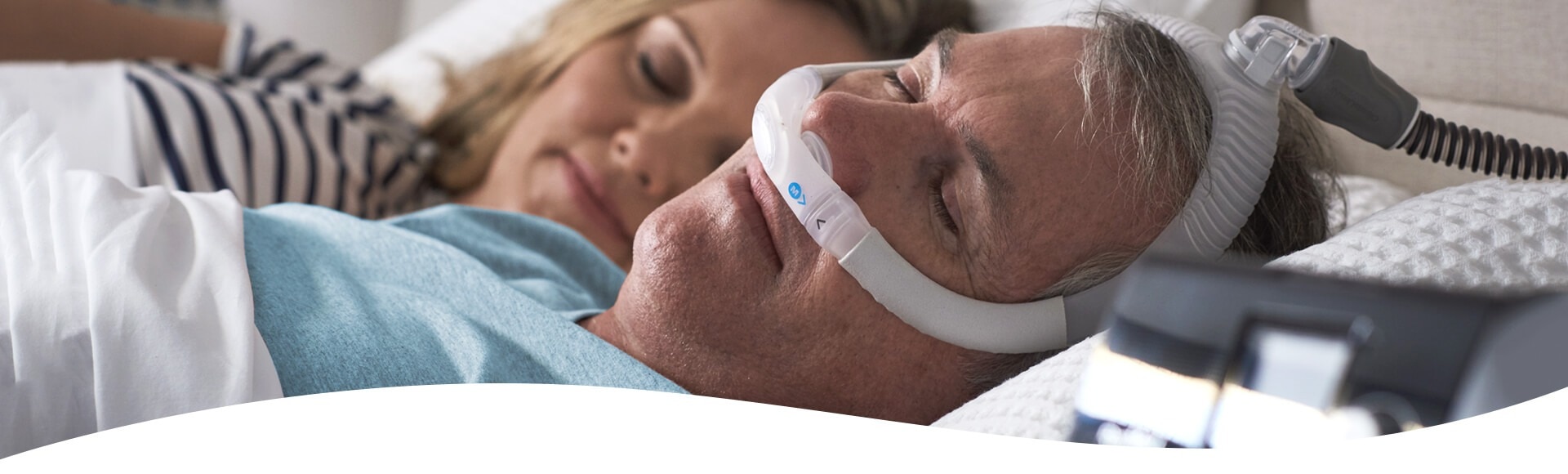 Mann traegt eine CPAP-Maske von ResMed